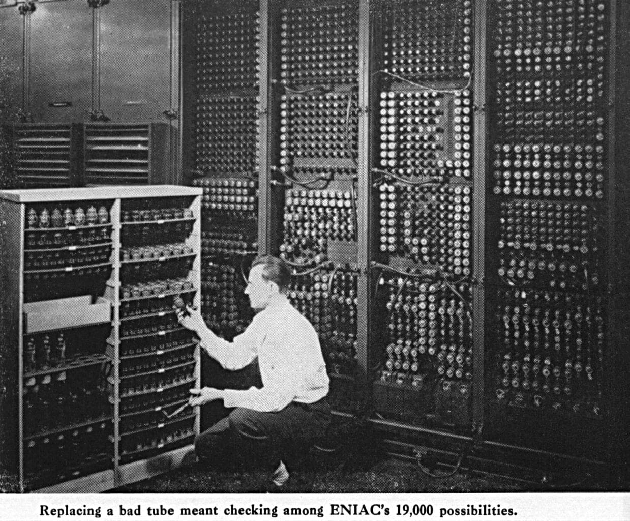 A technician replacing a vacuum tube in the ENIAC