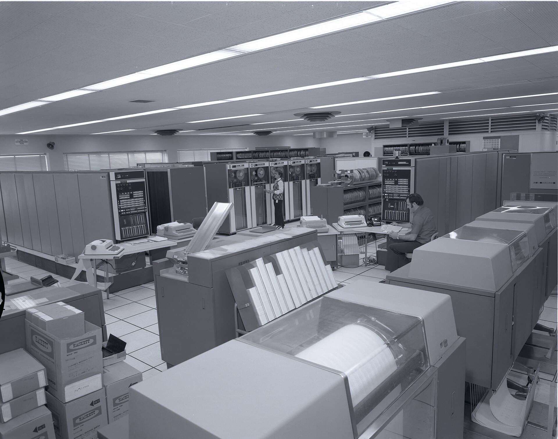 Rows of tape drives and printers in a computer room