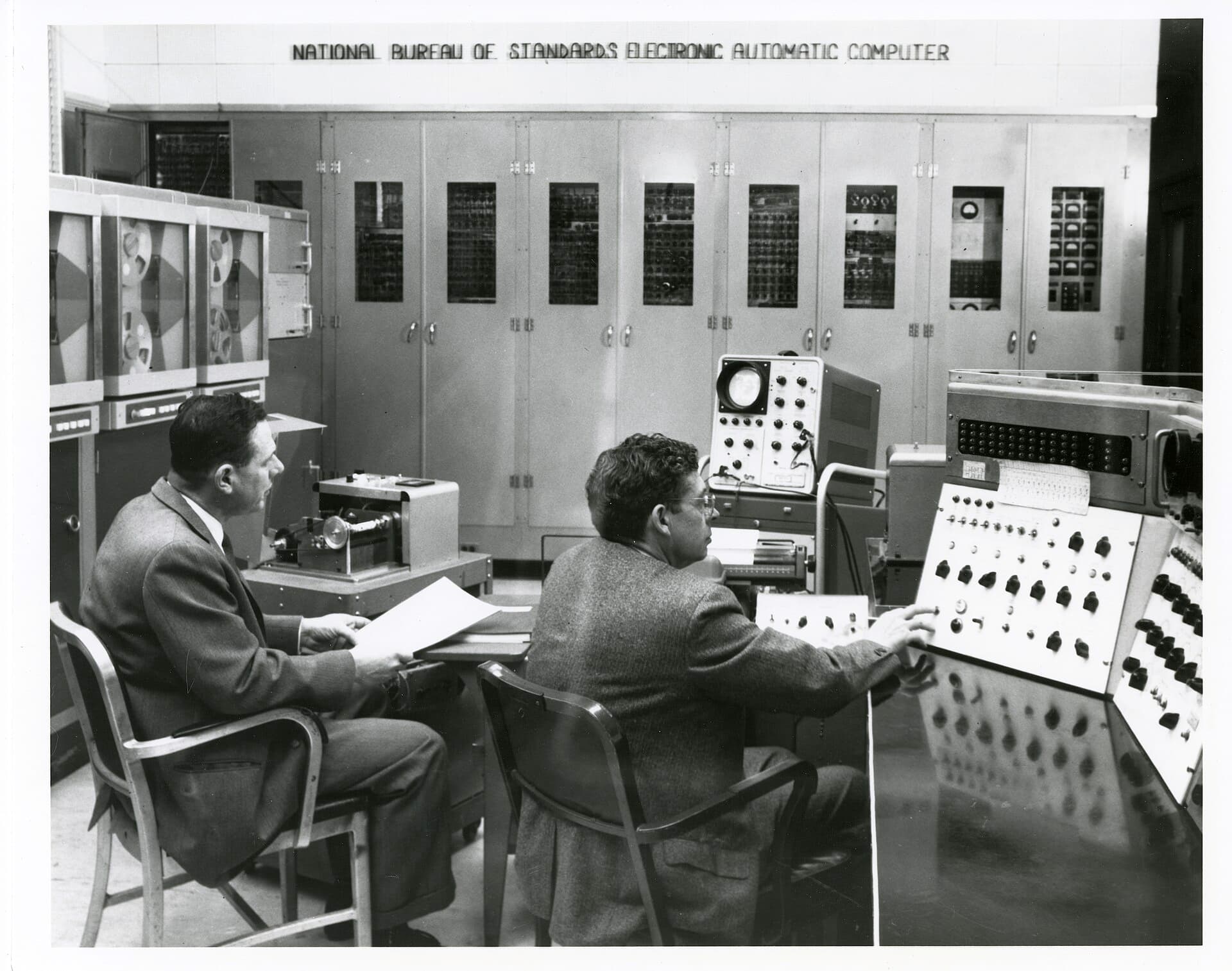 Operators at the SEAC console surrounded by equipment racks