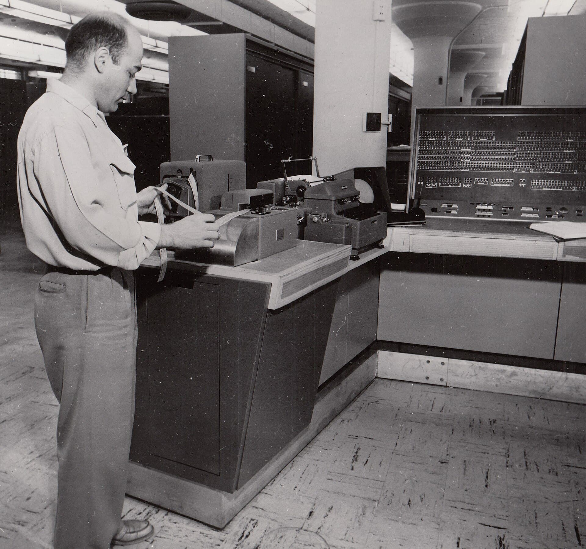An engineer at a UNIVAC 1105 with a Ferranti tape reader