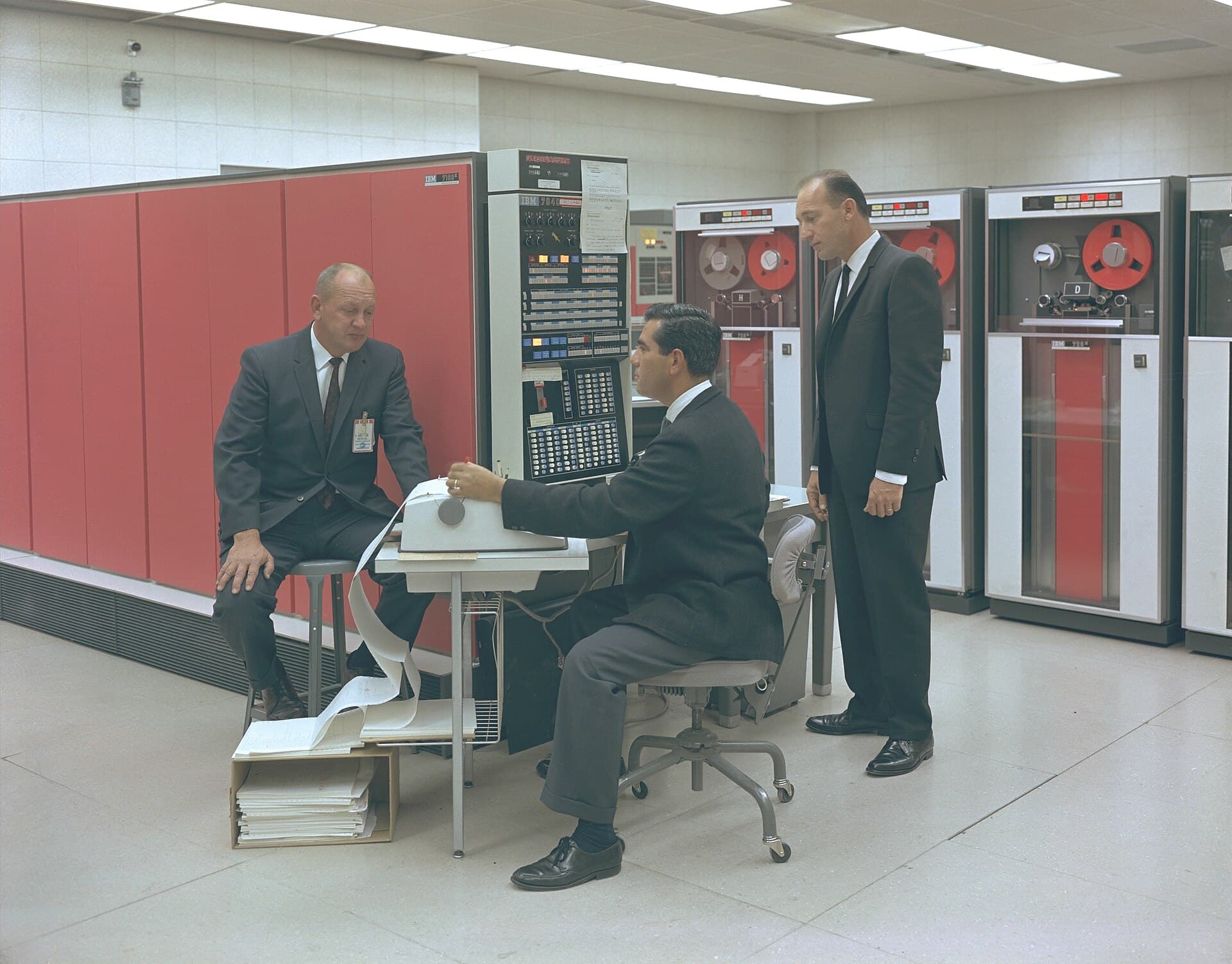 Engineers at a mainframe console in a 1966 computer room