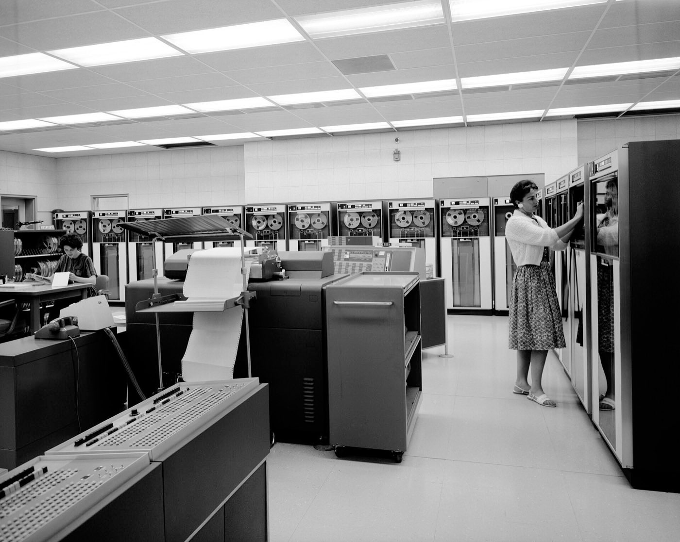 A 1960s NASA data processing room with rows of tape drives