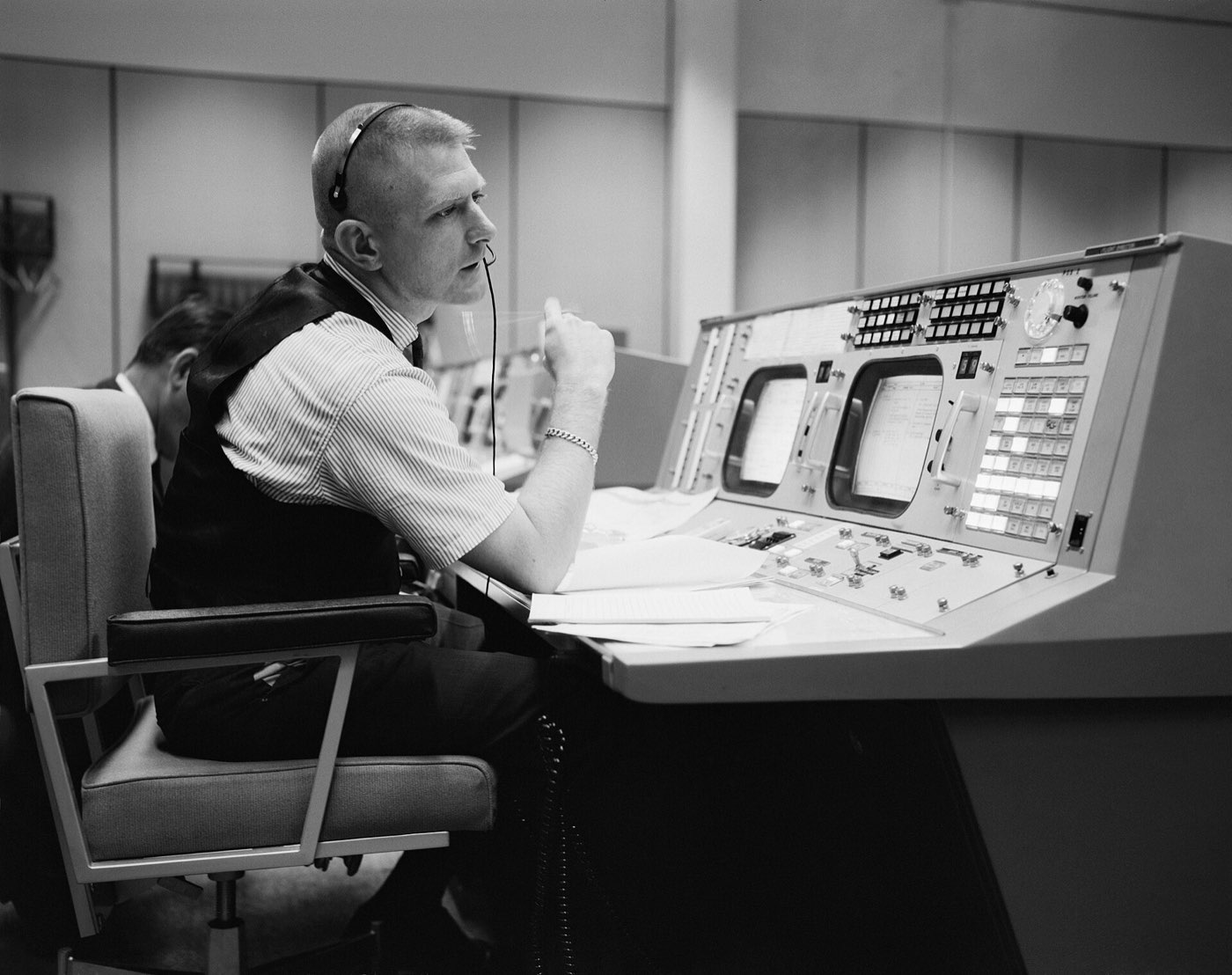 A flight controller at a console in NASA Mission Control